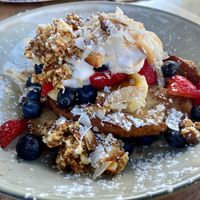 Sensational! Coconut infused French toast with banana, maple syrup, nut granola, shaved toasted coconut and fresh blueberries and strawberries at Black Bear Cafe in Bellingen