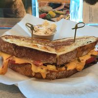 Southwest grilled cheese with a side of potato salad- black bean puree, tomato, vegan jack cheese, bell peppers, chipotle aioli on whole grain bread at The Hungry Caterpillar in Jacksonville