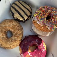 Peanut butter chocolate, cinnamon sugar, vanilla frosted, lavender oat milk glaze, and blueberry😄 at The Donut GroVe in Orono