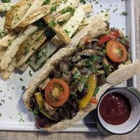 Philadelphia mushroom sandwich, with potato fries. at Mother Earth Vegan Restaurant in Tamarindo