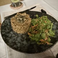 Mushroom risotto with salad  at Mother Earth Vegan Restaurant in Tamarindo