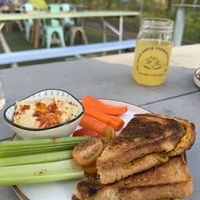 Fresh made hummus with side of veggies (tomatoes, carrots, celery) and vegan grill cheese   at Cultured South Fermentation Co in Atlanta
