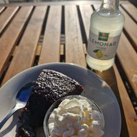 Fluffy mudcake with whipped cream and lemonade at Beijers Parks Cafe in Malmo
