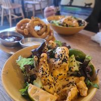 Twisted 'shrimp' in a spicy sauce ...AMAZING  & onion rings in the background at Vibes in Dorchester