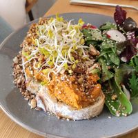 Spiced carrot (toasted sourdought topped with a baked carrot spread sprinkled with assorted spices (Fennel, cumin, walnuts) at Mana Food - Moabit in Berlin