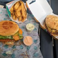 Spicy chick'n burger, steakhouse burger, herb fries, garden herb aioli, and spicy aioli. at PLNT Burger in Alexandria