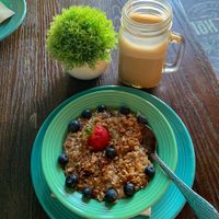 Oatmeal with fruit and crunchy granola, lavender oat milk hot latte   at Koffie House  in Key West