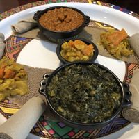 Collard entree, red lentil entree, and sides of cabbage and carrots  at Addis Nola in New Orleans