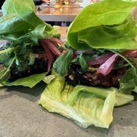 HARVEST SLIDERS (made vegan by lettuce wrap, no milk bun) 
carrot-cashew patty, almond satay, pea sprouts, pickled red onion, milk bun  at Flamingo's Lazeaway Club in Santa Rosa