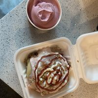Raspberry dole whip soft serve (already munched on) and a raspberry cheesecake cinnamon bun.  at Cinnaholic in Wilmington