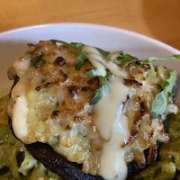 Portobello mushrooms stuffed with spinach risotto and vegan mozzarella.  at Norwood's Restaurant & Treehouse Bar in New Smyrna Beach