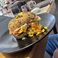 Crazy good bagel sandwich made vegan with tofu scrambleed eggs  at Buena Onda Cafe in St Augustine