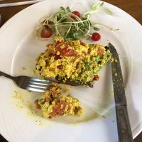 Half eaten avo, tofu scramble and tomato on sourdough   at Nang Sabai Cafe Artisan Bakery in Koh Samui