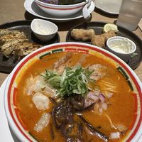 Spicy ramen (close), garlic oil ramen (far), gyoza and deep fried meat entrees    at Vegan Bistro Jangara in Tokyo