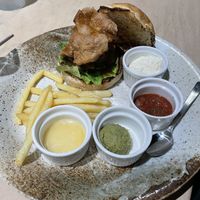 Burger with extra portion of soy meat. So many sauces and hardly any chips to dip in them 🥲  at Vegan Bistro Jangara in Tokyo
