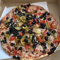One size pie, vegan cheese, olive, sweet peppers. Thin crust, really good! Definitely try it!  at Colony Grill in Milford