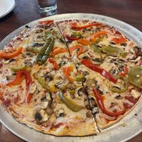 Pizza with vegan cheese, hot oil, sweet peppers, and mushrooms   at Colony Grill in Milford