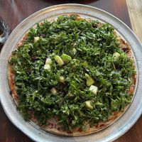 Winter kale salad pizza with vegan cheese at Colony Grill in Milford