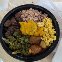 Jerk, rice n peas, Mac, oxtails, greens, and pumpkin at Uptown Veg in New York City