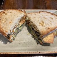 Smoked marinated tofu and smashed avo, pickled mushrooms, crispy shallots and homemade tahini dressing served in toasted sourdough at Copper and Moss in Shipley