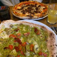 umami pizza - mince, mushrooms, oregano and mia pizza - tomatoes, sun dried tomatoes, artichokes, pistachios  at Marcus Pizze Amore in Paris