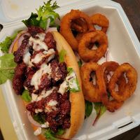 Rib sandwich and onion rings at Eliza's Vegan Café in Florence