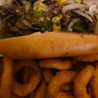 Cheesesteak and onion rings at Eliza's Vegan Café in Florence