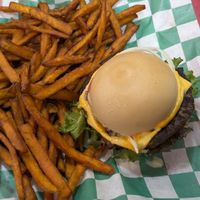 Cheeseburger on a gluten free bun with sweet potato fries. at Eliza's Vegan Café in Florence