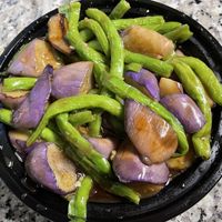 Eggplant loves green. It comes with white rice    at Fat Dragon in Austin