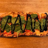 Vegantopia - vegan cheese, pelati tomato sauce, vegan bacon, spinach, balsamic drizzle at Pizzatopia in Wroclaw