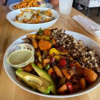 Protein bowl with truffle fries and Impossible  Burger in the background  at Earth Cafe in Myrtle Beach