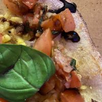 bruschetta pizza made with vegan cheese blend - generously topped with fresh ingredients.  at Cedar & Stone Wood-fired Pizza & Coffee in Wellington Point