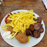 Starter plate for two. Crispy chicken, sausage, köfte and fries at The Vegan Regime in Istanbul
