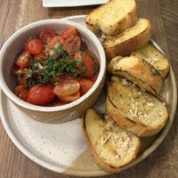 Garlic bread and tomatoes YUM  at PiANTA in Providence
