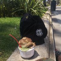 Enjoying this amazing pistachio, coco and hazelnut ice cream under a palm tree and blue sky 🥰 at Rivareno - Plaça de la Llotja in Mallorca