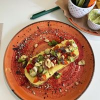 Vegan brunch - avo toast with cheese, hummus, Tomatos, nuts and raisins   at Coffee Break  in Salou