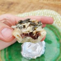 Small tart made of almond, chocolate inside, almond and pumpkinseeds on top. at Tant Grön in Vintrosa