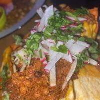 Close up of the plant based nachos! Vegan Cheeze and vegan queso with vegan chorizo and other garnishes!   at Luv Child in Tampa