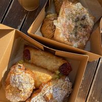 Front box: almond croissant & guava-cheese, Back: pizza pasty & ham-cheese croissants  at Chaumont Vegan in Beverly Hills