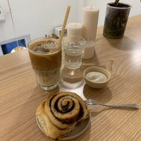 Earl Grey Cinnamon Roll with separate icing, together 🌏🇵🇸🇵🇸🌍🌎🌍⚖️🌎🇵🇸 with  a glass of smooth Oat milk coffee (Latte) at Rawberry in Ho Chi Minh City