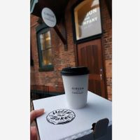 Oat milk latte and a box of vegan donuts  at Gibson & Company in Collingwood