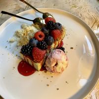 Pistacchio cheesecake with berries on top and a sort of shaved halva and amarema icecream   at Vrindaa in Rome