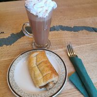 Hot chocolate with vegan cream and vegan sausage roll at Bumbles' Rest Cafe in Ambleside