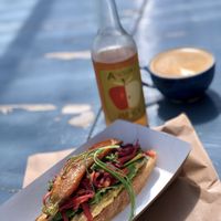Open hummus sandwich with fresh apple juice and a coffee  at The Bridge in Langport