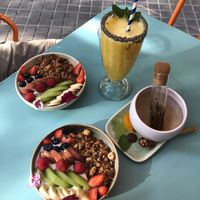 Chia and granola, coconut yogurt and granola, yellow smoothie, white tea  at Faire Brunch & Drinks in Barcelona