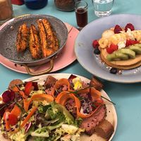 Sweet potatoes, avocado/beet toast, and pancakes with fruit  at Faire Brunch & Drinks in Barcelona