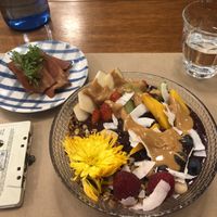 Açaí bowl with peanut butter topping, vegan bacon and a cassette deck with a QR code for the menu! Fits with the 80’s music playing and a retro vibe decor   at Faire Brunch & Drinks in Barcelona