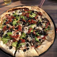 Veggie pizza (vegan) with Daiya cheeze and whole wheat crust. Seriously under cooked. By the obsession with raw vegetables on a pizza?? I substituted sun dried tomatoes for raw.   at Woodstock's Pizza in Davis