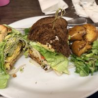 Vegan egg and bacon sandwich and the Vegan BLAT sandwich with salad and breakfast potatoes.   at Island Vintage Wine Bar in Honolulu