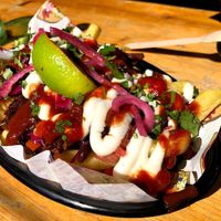 Dirty vegan fries (pulled jackfruit, guac, pickles, smoked garlic mayo) at Cantina Carnitas in Hitchin